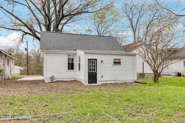 rear view of house featuring a lawn