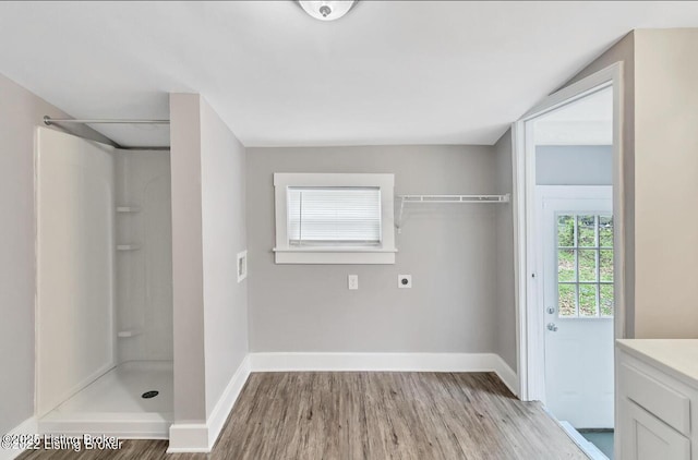 bathroom with a shower, hardwood / wood-style flooring, and vanity