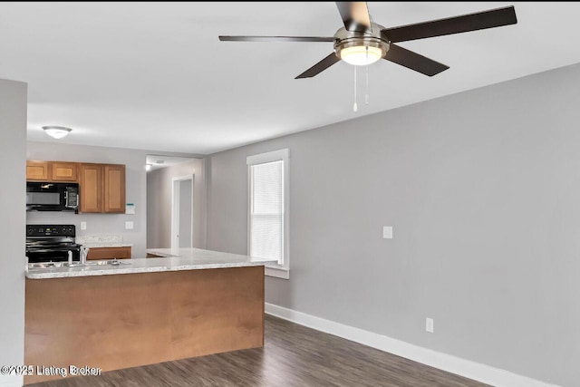 kitchen featuring ceiling fan, kitchen peninsula, range with electric cooktop, dark hardwood / wood-style flooring, and light stone counters