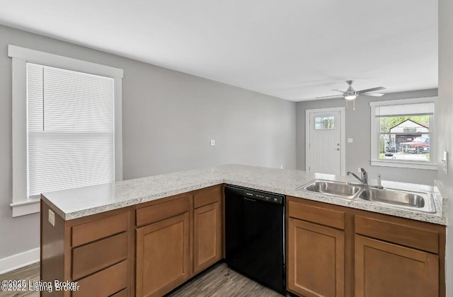 kitchen featuring dishwasher, wood-type flooring, sink, kitchen peninsula, and ceiling fan