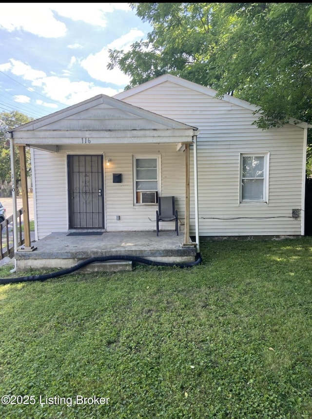 rear view of property with a porch and a lawn