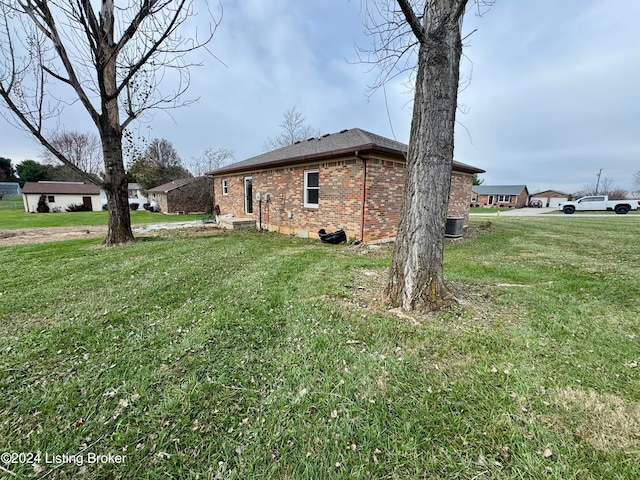 view of side of property with a yard