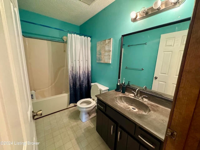 full bathroom with vanity, toilet, a textured ceiling, and shower / tub combo