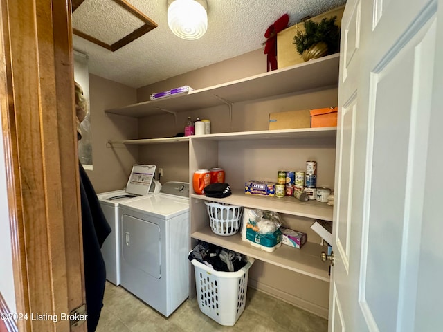 washroom with separate washer and dryer and a textured ceiling