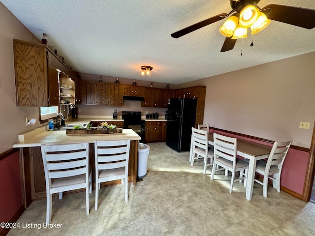 kitchen featuring ceiling fan, sink, kitchen peninsula, a textured ceiling, and black appliances