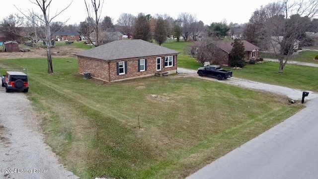 view of front of property with a front lawn and cooling unit