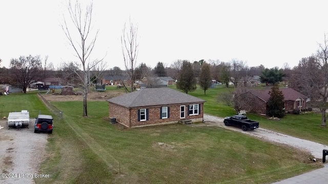 view of front of house with central AC unit and a front yard