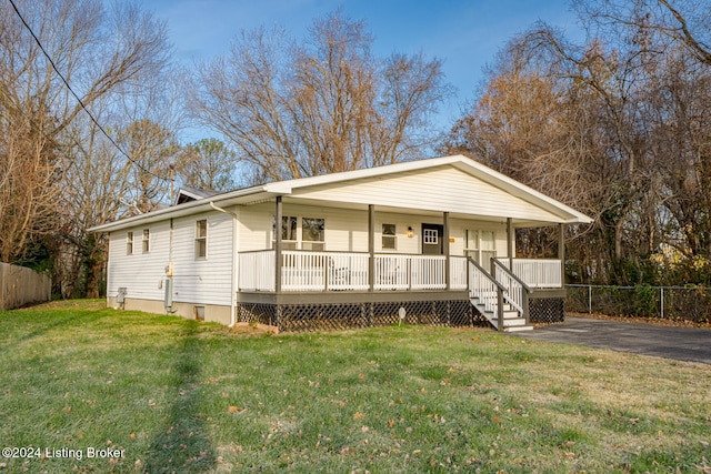 view of front of home with covered porch and a front yard