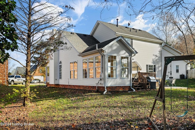 back of house with a yard, a wooden deck, and central AC