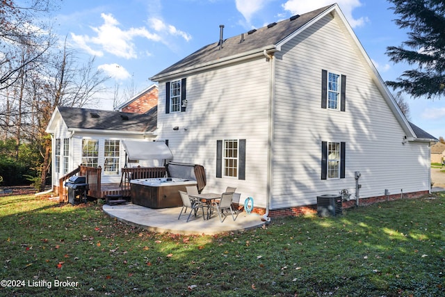 back of property featuring a deck, a yard, a patio, and central AC