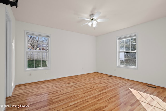 unfurnished room featuring ceiling fan and light wood-type flooring