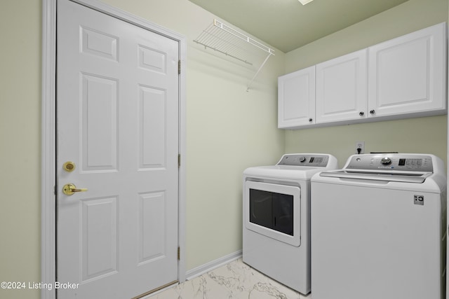 washroom featuring cabinets and separate washer and dryer