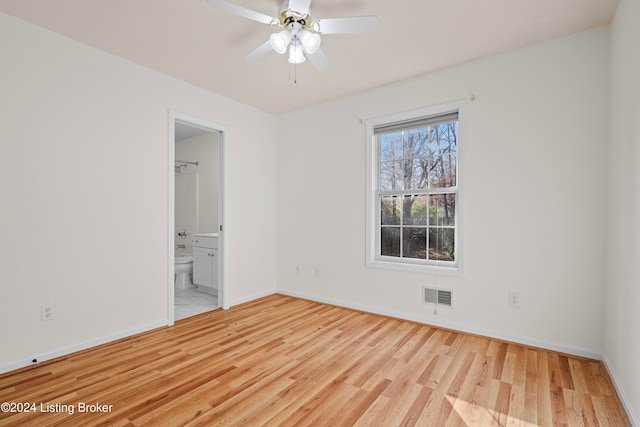 unfurnished bedroom with ensuite bathroom, light hardwood / wood-style flooring, and ceiling fan