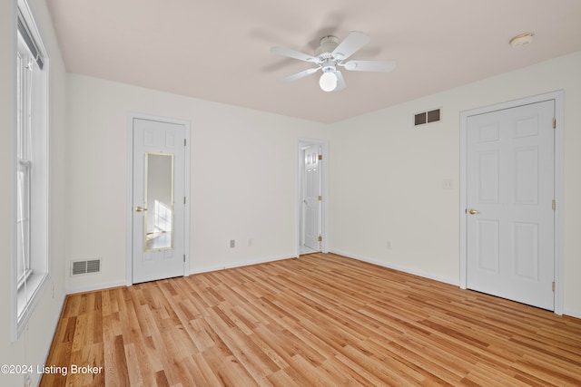 unfurnished bedroom with ceiling fan and light wood-type flooring