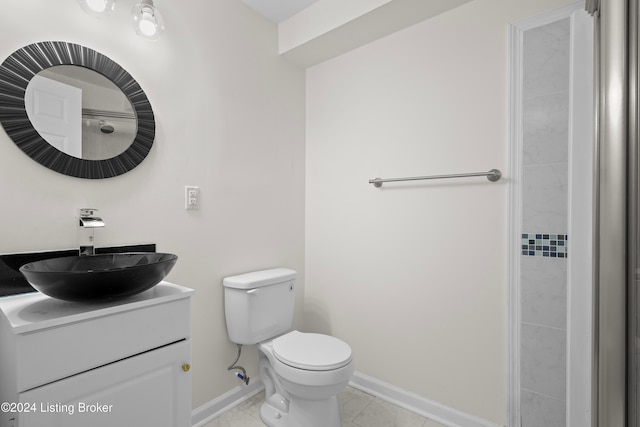 bathroom featuring tile patterned flooring, vanity, and toilet