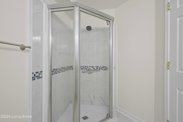 bathroom featuring a shower with door