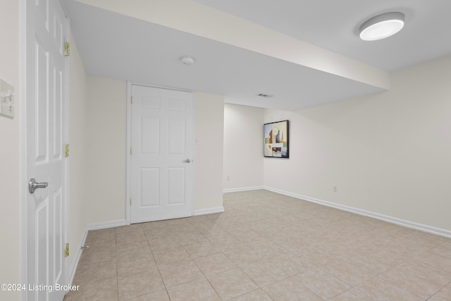 basement featuring light tile patterned floors