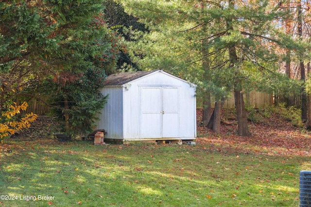 view of outbuilding with a yard