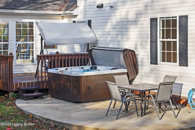 wooden terrace with a patio and a hot tub