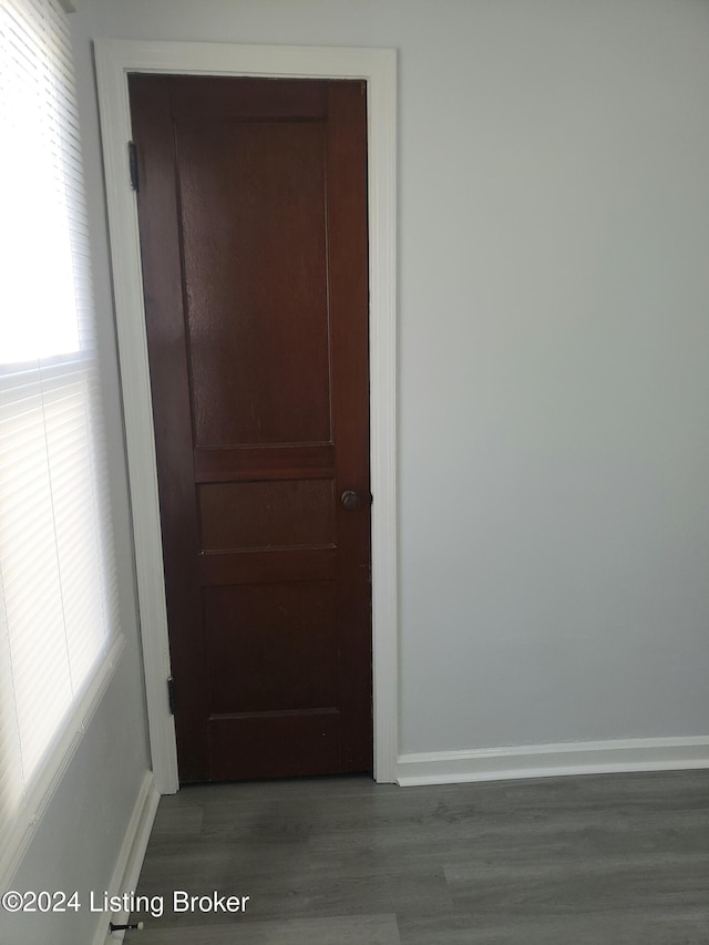 corridor with dark hardwood / wood-style floors