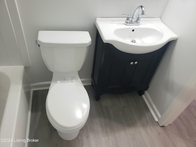 bathroom with vanity, toilet, and wood-type flooring