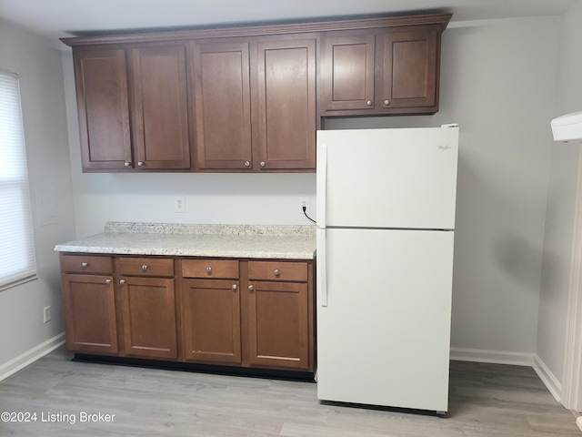 kitchen with light wood-type flooring and white fridge