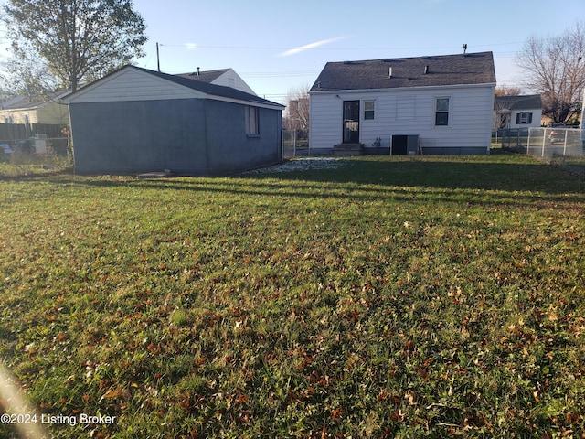 back of property with cooling unit and a yard