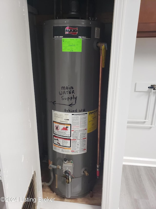 utility room featuring gas water heater