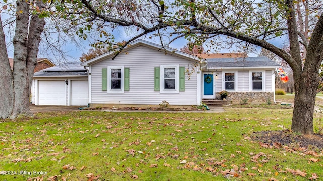 ranch-style home with solar panels, a garage, and a front lawn