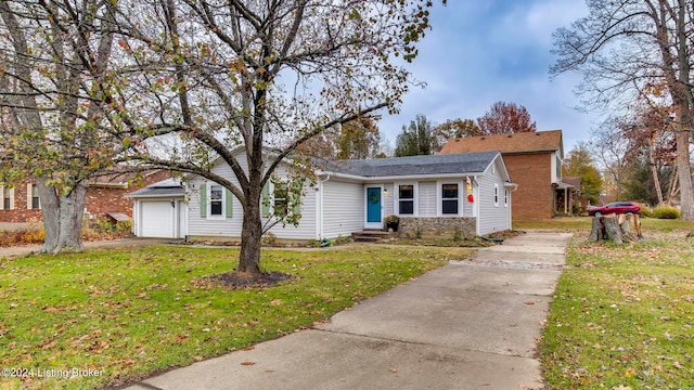 view of front of home with a front yard and a garage