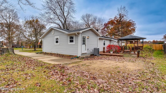 rear view of house featuring a gazebo, a deck, and central air condition unit