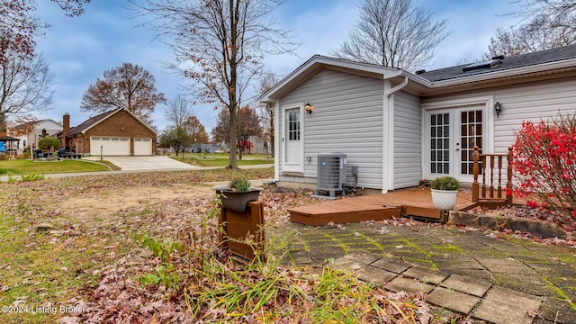 view of side of home with a wooden deck and central AC unit