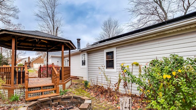 exterior space with a gazebo, a fire pit, and a deck