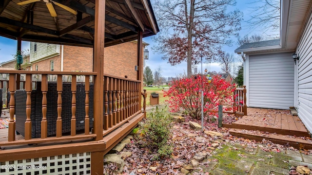 view of yard with ceiling fan and a wooden deck