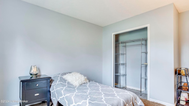 bedroom with carpet and a closet