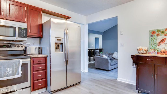 kitchen featuring stainless steel appliances and light hardwood / wood-style floors