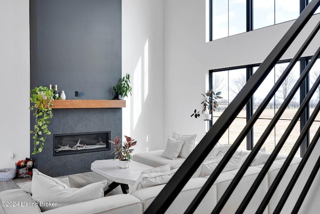 living room featuring a fireplace and a towering ceiling