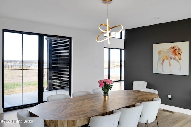 dining area featuring a chandelier and light hardwood / wood-style flooring