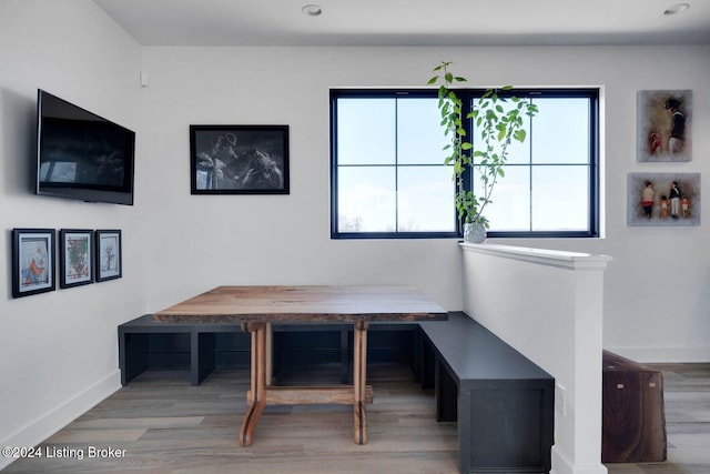 unfurnished dining area featuring breakfast area and hardwood / wood-style flooring