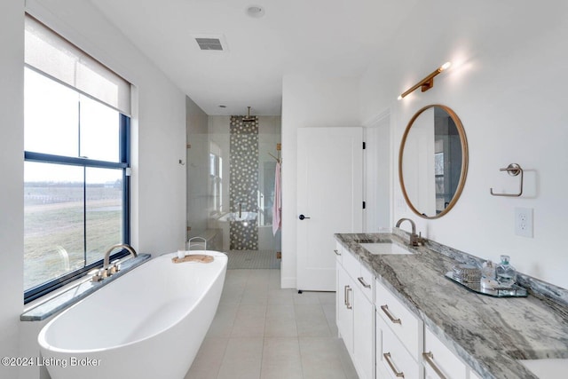 bathroom with separate shower and tub, tile patterned flooring, vanity, and a healthy amount of sunlight