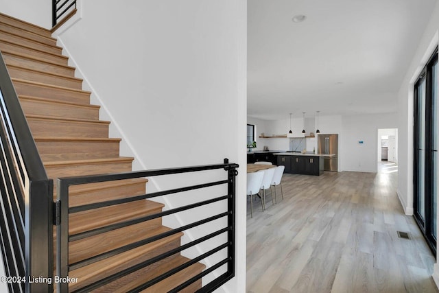 stairway featuring wood-type flooring