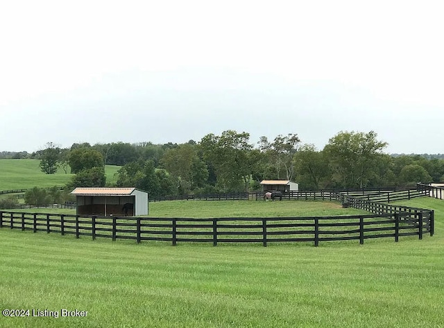 view of yard with a rural view and an outdoor structure