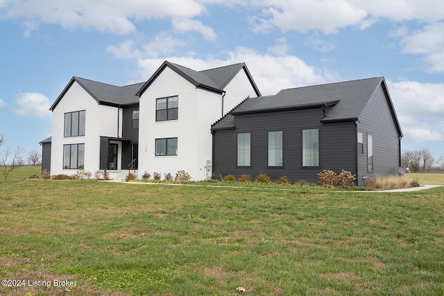 modern farmhouse with a front lawn