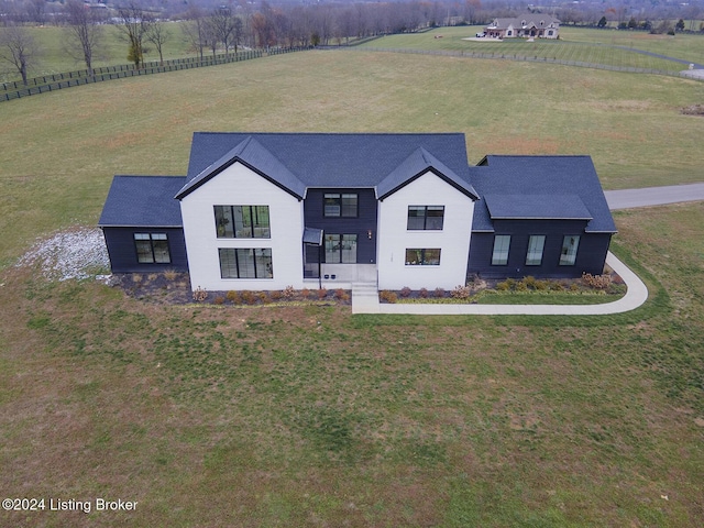 view of front of house featuring a rural view and a front lawn