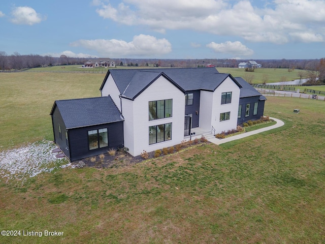 view of front of home featuring a rural view and a front lawn