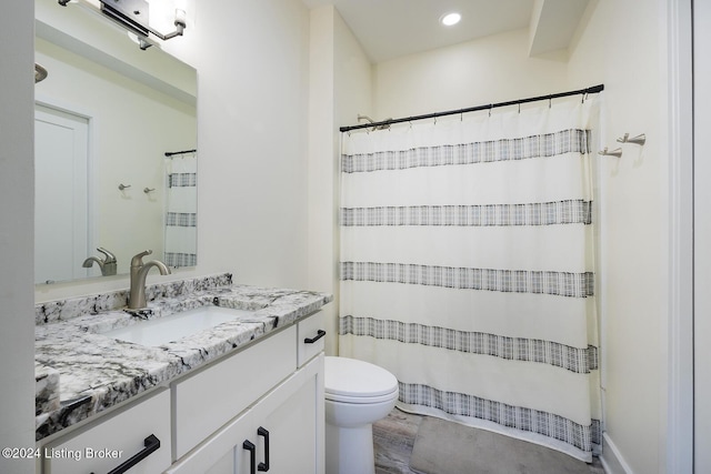 bathroom with walk in shower, vanity, wood-type flooring, and toilet