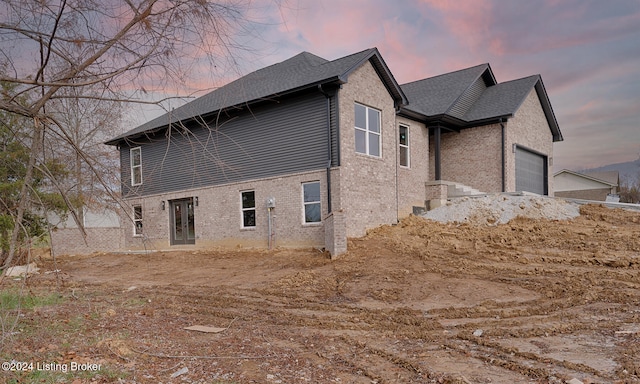 property exterior at dusk with a garage