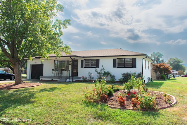 single story home with a front yard, a porch, and a garage