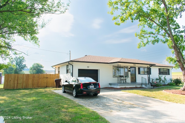 ranch-style home with a front lawn, a porch, and a garage