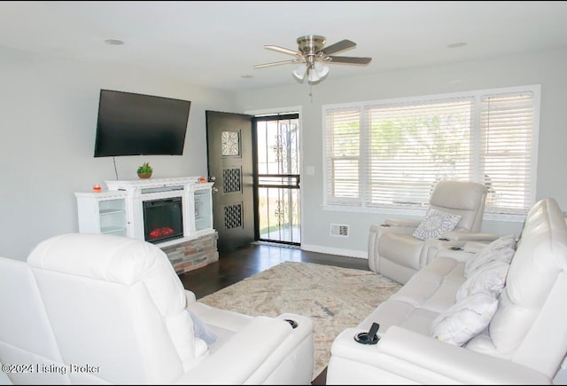 living room featuring ceiling fan and dark hardwood / wood-style flooring